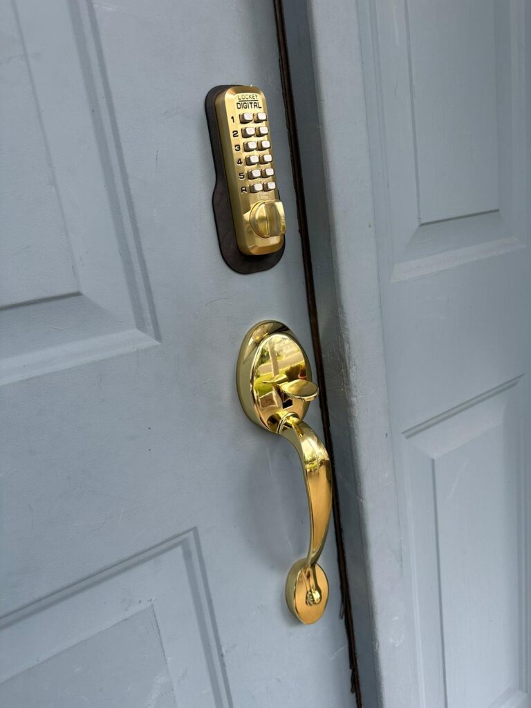 A light blue door slightly ajar with a gold handle and a digital keypad lock installed above it, perfect for upgrading your local security or finding a trusted locksmith near me.